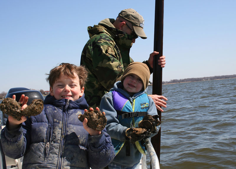 kids holding up oysters