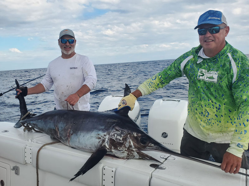 anglers with a swordfish caught during daytime