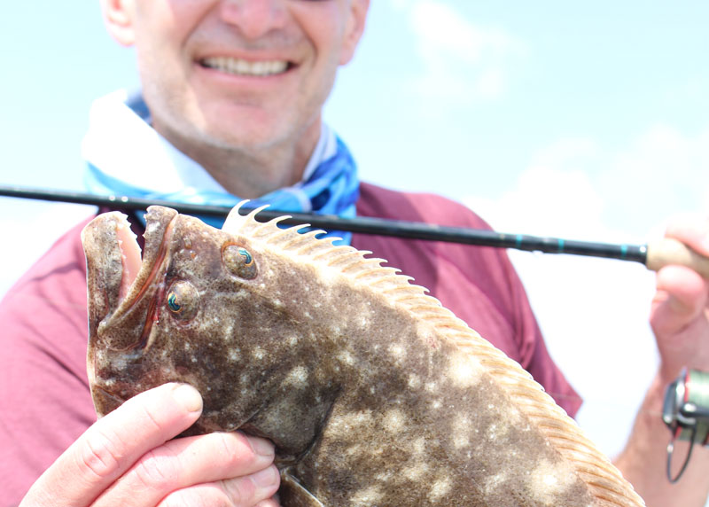 angler with a flounder