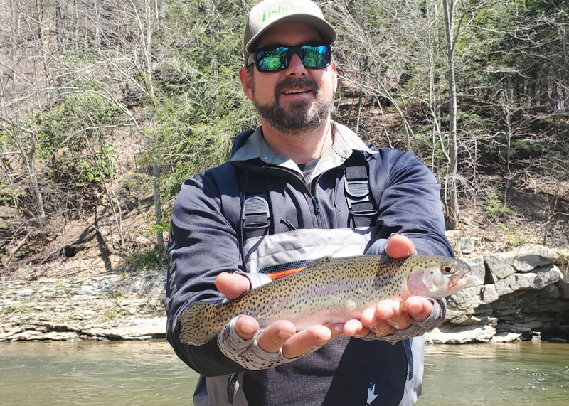 fly fisherman with a rainbow trout