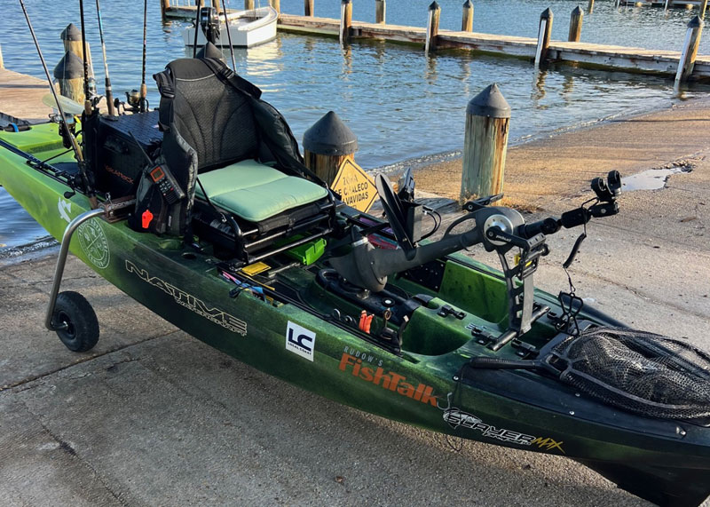 a fishing kayak with a seat cushion