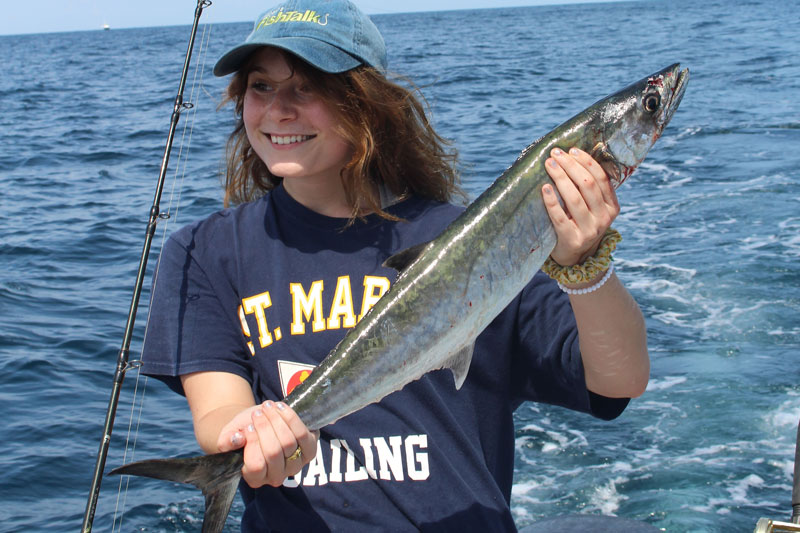 angler holds up a king mackerel