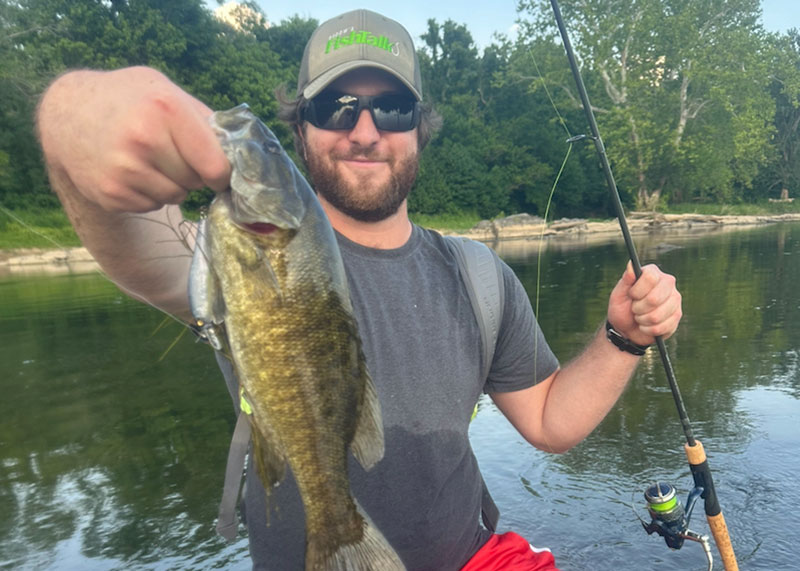 fishing for smallmouth bass while wading in a river