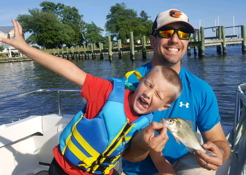kid catching white perch